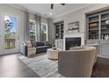 Cozy living room with fireplace, built-in bookshelves, hardwood floors, and natural light at 4651 Eddibunn Se Dr, Smyrna, GA 30080