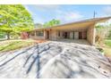 Inviting exterior view featuring brick facade, well-maintained lawn and covered parking at 1955 Starr Sw Rd, Conyers, GA 30094