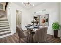 Dining room with wood floors, modern light fixture, and staircase at 1045 Mcdaniel St, Atlanta, GA 30310