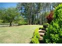 Expansive backyard features a lush lawn, mature trees, and tasteful landscaping at 84 Nw Gloster Nw Rd, Lawrenceville, GA 30044