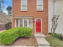 Close-up of the front entrance showing a bright red door and neatly trimmed landscaping at 193 High Creek Dr, Roswell, GA 30076