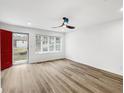 Bright living room featuring hardwood floors, modern ceiling fan, and large windows offering ample natural light at 193 High Creek Dr, Roswell, GA 30076