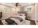 Cozy bedroom with natural light, a large bed, wood floors and stylish decor at 2183 Seaman Cir, Atlanta, GA 30341