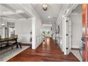 Inviting foyer with gleaming hardwood floors, white trim, and coffered ceilings, creating a grand entrance at 260 Millstone Pkwy, Woodstock, GA 30188