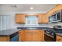 A bright kitchen with stainless steel appliances, and light wood cabinets at 2960 Fields Dr, Lithonia, GA 30038