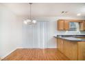 Inviting kitchen with wood cabinets, granite countertops, and a view of the adjacent dining area at 2960 Fields Dr, Lithonia, GA 30038