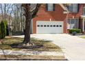 Attached two-car garage featuring driveway and partial view of front lawn at 3220 Warren Creek Dr, Powder Springs, GA 30127