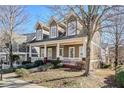 Attractive two-story home featuring a covered porch with decorative columns and a well manicured lawn at 2165 Parkview Nw Run, Atlanta, GA 30318