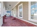 Covered front porch with brick flooring, white columns, and ample space for relaxing at 2165 Parkview Nw Run, Atlanta, GA 30318