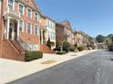 Charming street view of well-maintained brick townhomes in a desirable neighborhood at 4621 Wehunt Commons Se Dr # 7, Smyrna, GA 30082