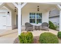 Cozy front porch featuring comfortable seating, stylish lighting, and a charming spot to enjoy the outdoors at 161 Grace Cir, Acworth, GA 30102