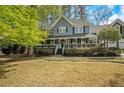 Charming two-story home with attached two-car garage and well-manicured landscaping, including a covered front porch at 3320 Woodsfield Ne Dr, Marietta, GA 30062