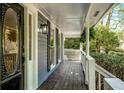 View of the front porch showcasing dark-stained wood, ferns, and decorative door with leaded glass at 3320 Woodsfield Ne Dr, Marietta, GA 30062