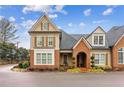Attractive two-story house with brick and siding, complemented by well-kept landscaping and blue skies at 19 Lindley Nw Ave, Marietta, GA 30064