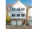 New construction home featuring a stone base, white siding, and black window frames at 220 Alcovy Terrace, Alpharetta, GA 30009