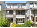 Elegant townhome with covered porch, double doors, and beautiful landscaping at 914 Martin Nw St, Atlanta, GA 30318