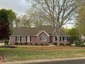 Attractive brick home featuring well-maintained landscaping and a neatly manicured front lawn at 2025 Golden Ridge Cir, Cumming, GA 30040