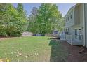 Expansive back yard featuring a storage shed and access to an outdoor deck at 2775 Whippoorwill Cir, Duluth, GA 30097