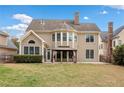 Backyard with a gazebo, expansive lawn, mature trees, and a view of the home's rear elevation at 552 Lawton Bridge Sw Rd, Smyrna, GA 30082