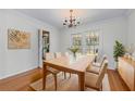 Formal dining room with hardwood floors, chandelier, and access to outdoor spaces at 2350 Powers Ferry Se Dr, Marietta, GA 30067