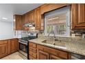 Updated kitchen featuring granite countertops, stainless steel appliances, and wood cabinets at 2350 Powers Ferry Se Dr, Marietta, GA 30067