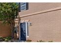 Exterior facade of a brick building featuring a dark blue front door with house numbers at 4095 Stillwater Dr, Duluth, GA 30096