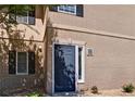 Dark blue front door of a tan brick building, featuring classic design and natural lighting at 4095 Stillwater Dr, Duluth, GA 30096