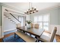 The dining room has a stylish light fixture, table, chairs, and a bench at 717 Robinson Farms Dr, Marietta, GA 30068