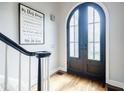Bright foyer featuring hardwood floors and an elegant staircase at 717 Robinson Farms Dr, Marietta, GA 30068