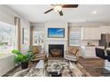 Bright living room featuring a fireplace, ceiling fan, and sleek furnishings at 6352 Towhee Way, Morrow, GA 30260