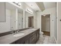 Bathroom featuring double sinks, subway tile, marble floors, and a walk-in closet at 1100 Howell Mill Nw Rd # 408, Atlanta, GA 30318