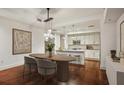 Dining room with a modern light fixture with a view of the kitchen and island at 1100 Howell Mill Nw Rd # 408, Atlanta, GA 30318