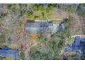 Overhead view of the home showcasing the roof, driveway, and surrounding tree coverage at 120 Maryeanna Ne Dr, Atlanta, GA 30342