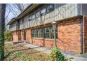 Brick home exterior featuring a walking path, mature landscaping, and a vintage outdoor lamp at 120 Maryeanna Ne Dr, Atlanta, GA 30342
