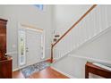Bright foyer with hardwood floors, staircase, and a view of the front door at 179 Country Club Dr, Hiram, GA 30141