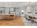 Open kitchen and dining area with gray cabinets and modern light fixtures at 2018 Presley Ne Way, Atlanta, GA 30317