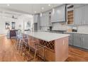 Spacious kitchen featuring gray cabinets, a large island, and modern lighting at 2018 Presley Ne Way, Atlanta, GA 30317