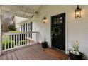 Charming porch featuring a welcome mat, wreath, and potted flowers by the front door at 1068 Gwens Sw Trl, Lilburn, GA 30047