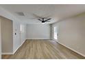 Spacious living room featuring neutral paint, modern ceiling fan and wood-look flooring throughout the room at 4480 Maple Valley Dr, Cumming, GA 30040