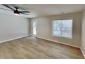 Bright living area with fresh paint, wood-look flooring, a glass patio door and a window providing lots of natural light at 4480 Maple Valley Dr, Cumming, GA 30040