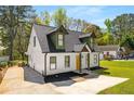 An alternative angle showcasing this charming home, including the driveway and well-manicured lawn at 1071 N Price Rd, Sugar Hill, GA 30518