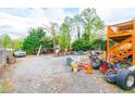 Large backyard area covered in gravel with storage, equipment, and a small shed at 1486 Harbins Rd, Norcross, GA 30093