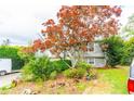 Lovely home with mature landscaping, a large tree, and a well-maintained lawn at 1486 Harbins Rd, Norcross, GA 30093