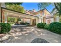 Spacious driveway featuring covered parking, mature trees, and manicured landscaping at 8 W Andrews Nw Dr, Atlanta, GA 30305