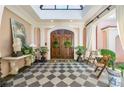 Welcoming foyer with dark wood double doors, checkered floors, and natural light at 8 W Andrews Nw Dr, Atlanta, GA 30305