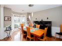 Elegant dining room with hardwood floors, modern lighting, and a large bay window at 1037 Dunedin Trl, Woodstock, GA 30188