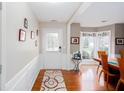Inviting foyer with hardwood floors, white wainscoting, and a view into the dining room at 1037 Dunedin Trl, Woodstock, GA 30188