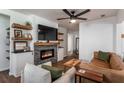 Bright living room with modern fireplace, mounted TV, and floating shelves at 2189 Gordon Se Cir, Smyrna, GA 30080