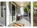 Inviting covered front porch featuring cozy seating, plants, and a decorative wreath on the front door at 1257 Lyle Pl, Atlanta, GA 30318