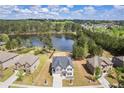Stunning aerial view of a two-story home with lake access and mature landscaping at 1861 Poplar Falls Ave, Lithonia, GA 30058